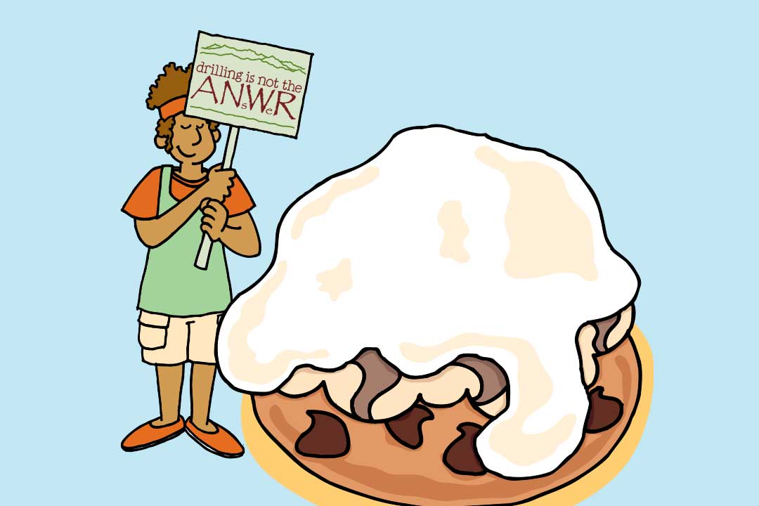 En dame holder skiltet “Drilling is Not the ANsWer” ved siden af et stykke baked Alaska 